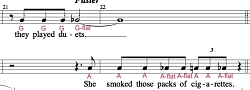 Two measures from the 'CAROLINE, OR CHANGE' full score, with vocal notes designated with red greek alphabetical letters