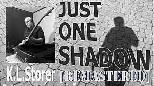 K.L.Storer's 'Just One Shadow' music video poster frame with a b&w photo of K.L. playing bass guitar and a photo of a single male shadow on a cobblestone surface