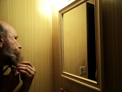 K.L.Storer cutting his beard off with barber shears for an audition
